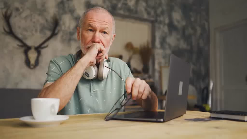 A worried man looking at his finances.